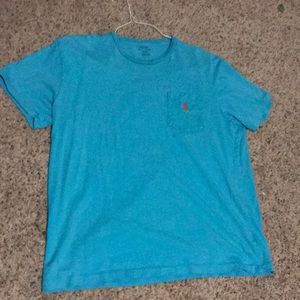 Blue polo shirt with orange logo and chest pocket